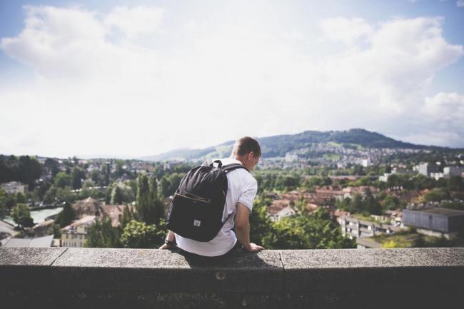 student sitting on a wall