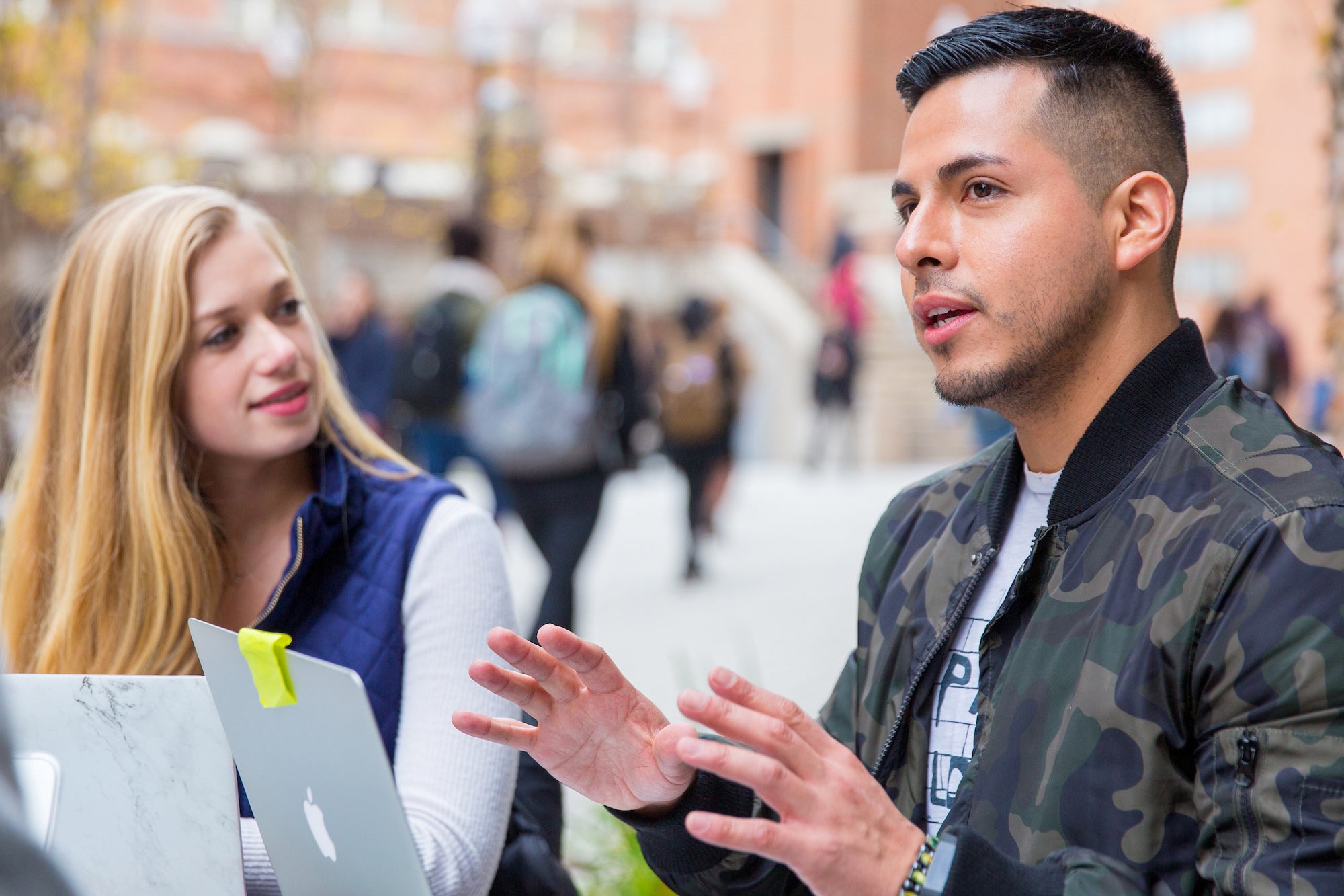 Students in a discussion seated outside 