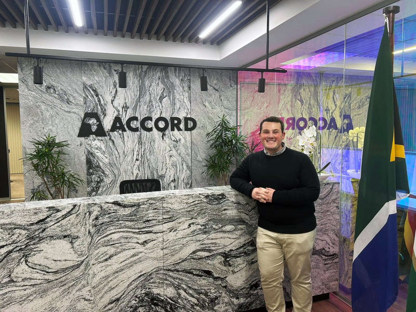 Student standing in front of a reception desk at Accord