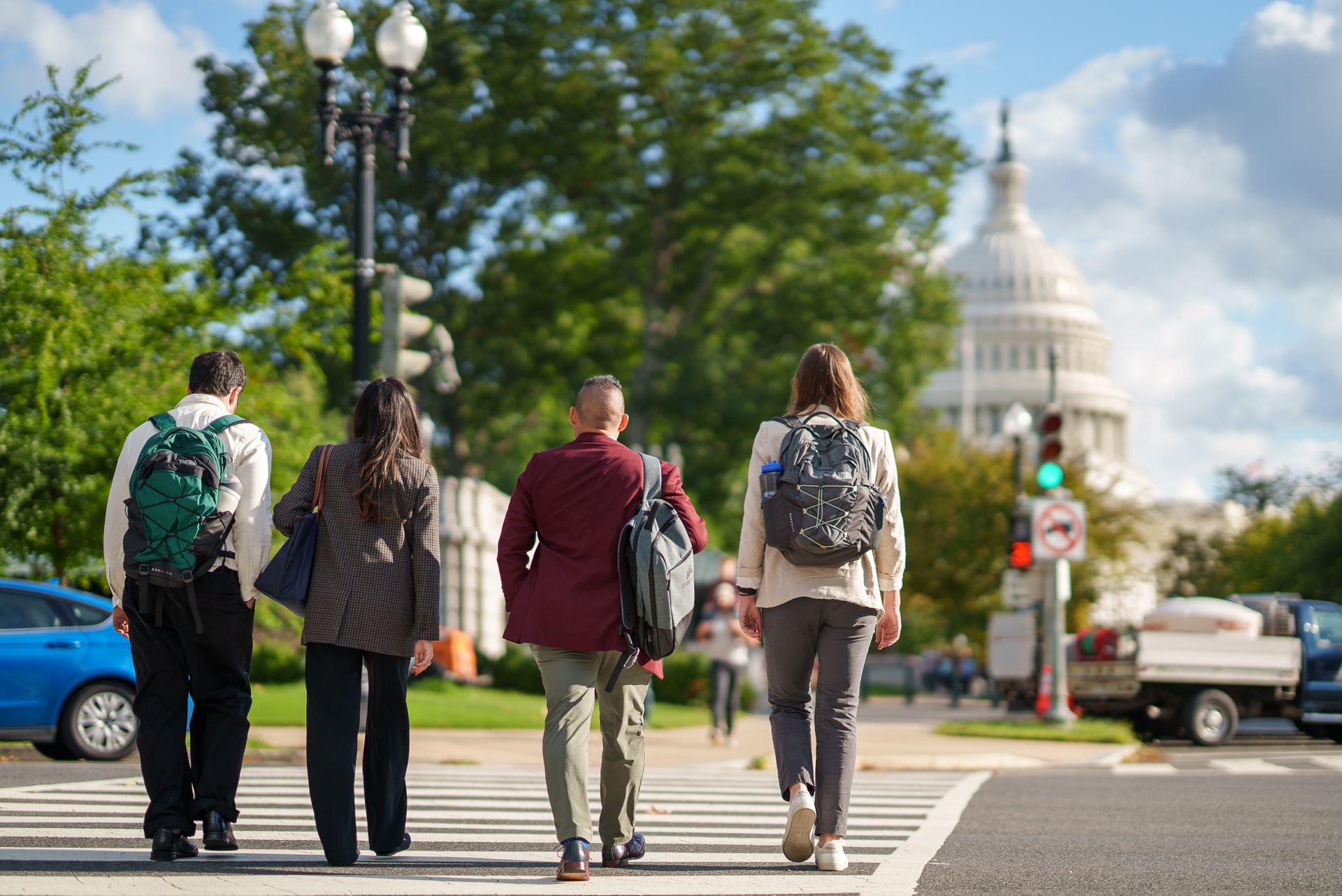 Four students walk toward the US Capitol building.
