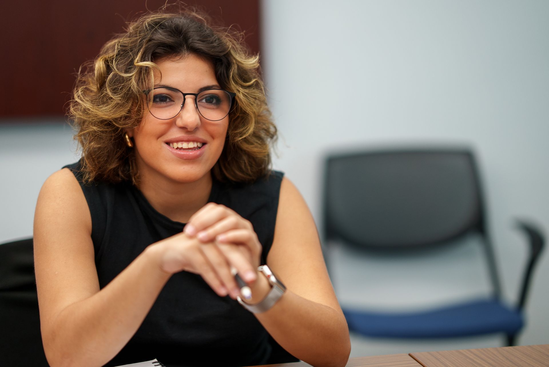 A student smiling in class.