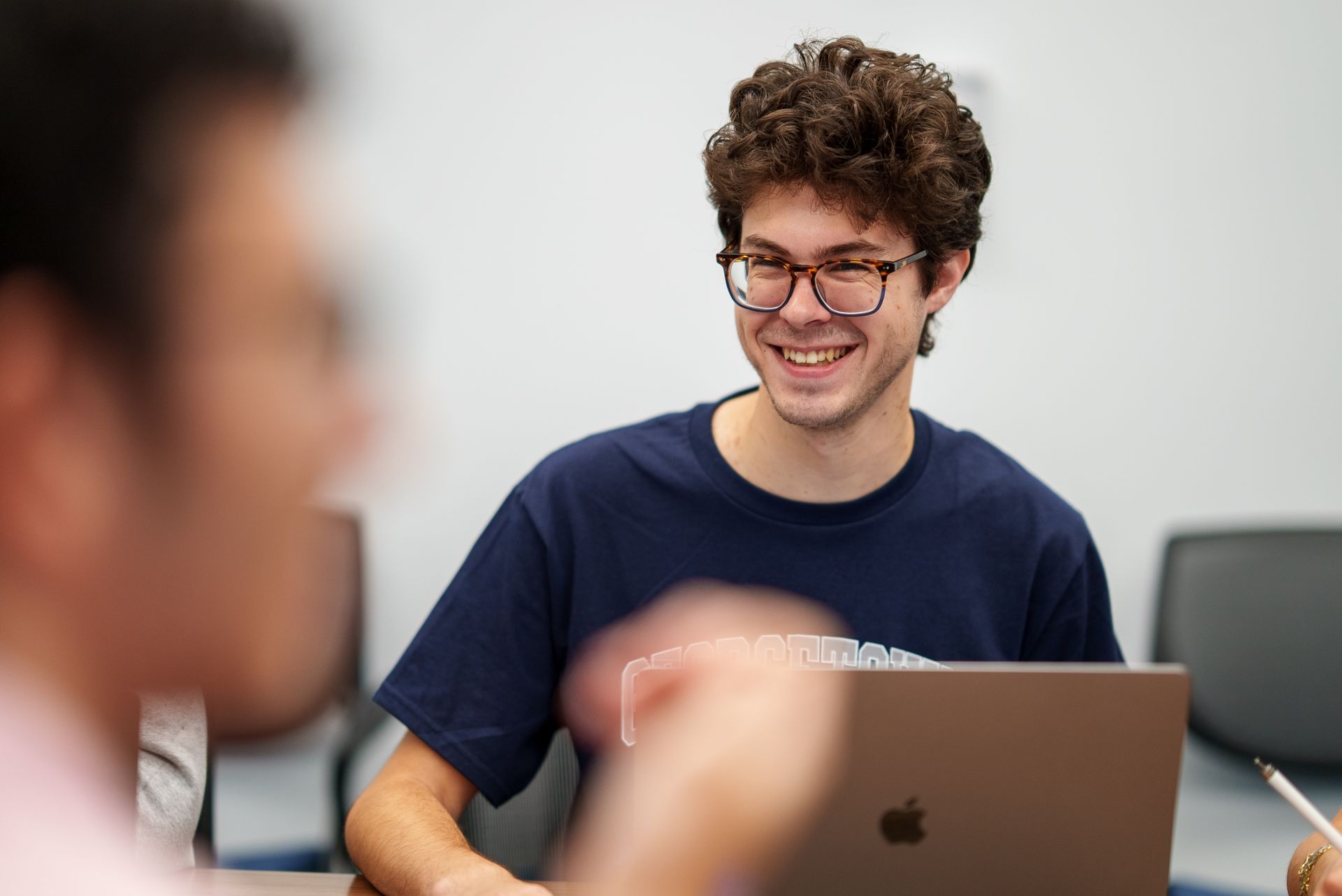 A student smiling in class.
