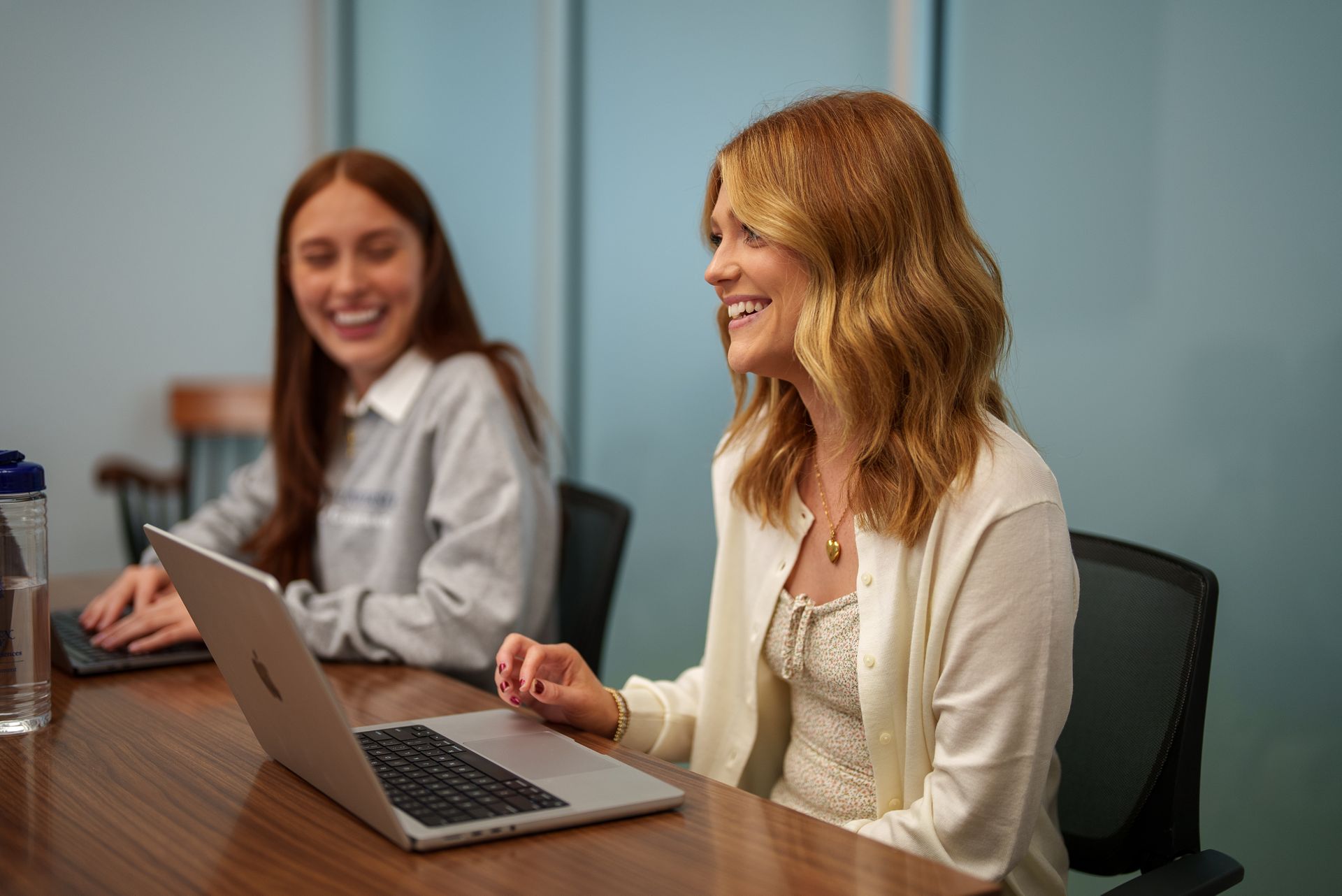 Two students smiling in class.
