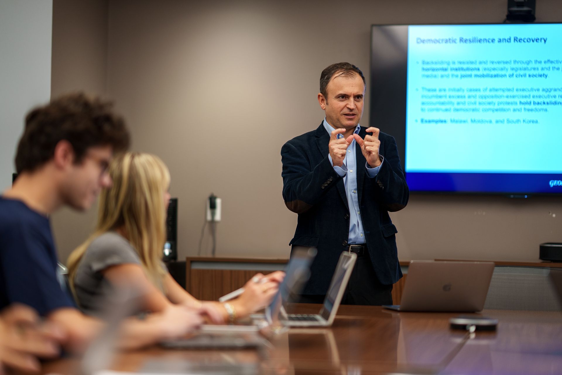 An instructor teaches class.