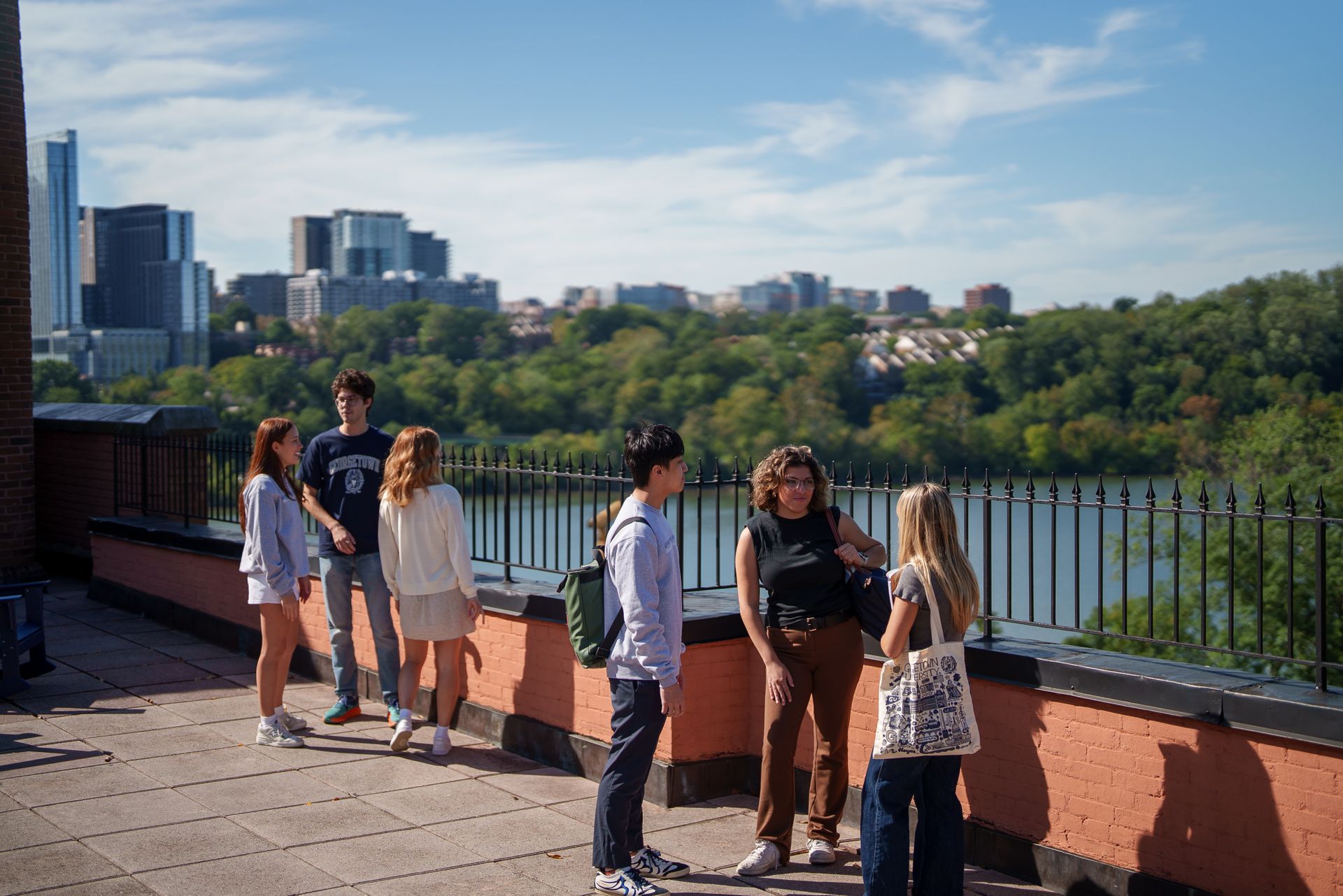 Six students hanging out together outside of the Car Barn.