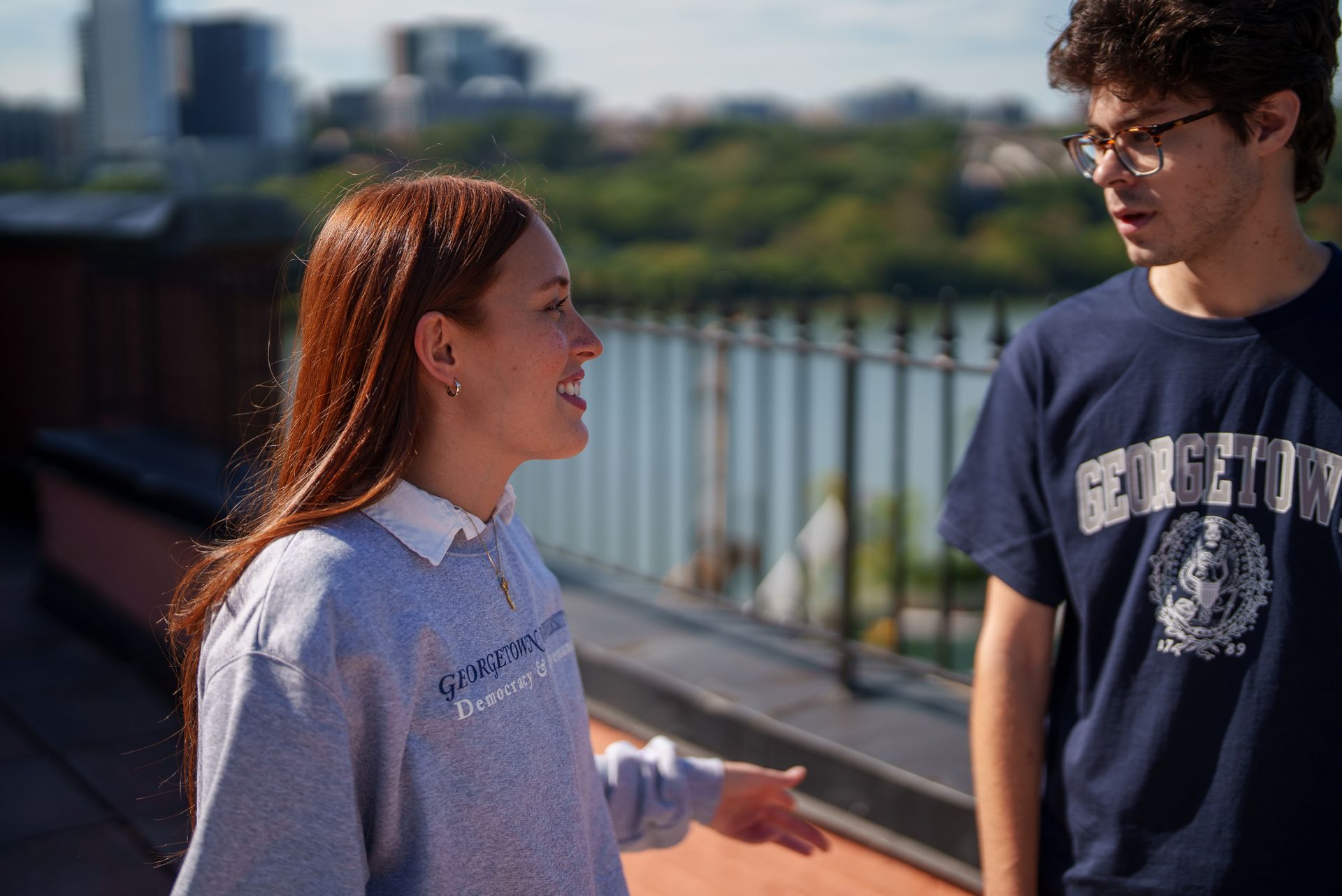 Two students talk together outside of the Car Barn.
