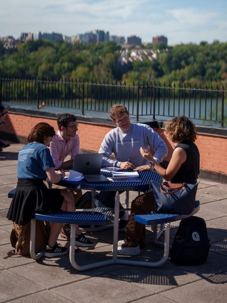 Students outside of the Car Barn Studying together.