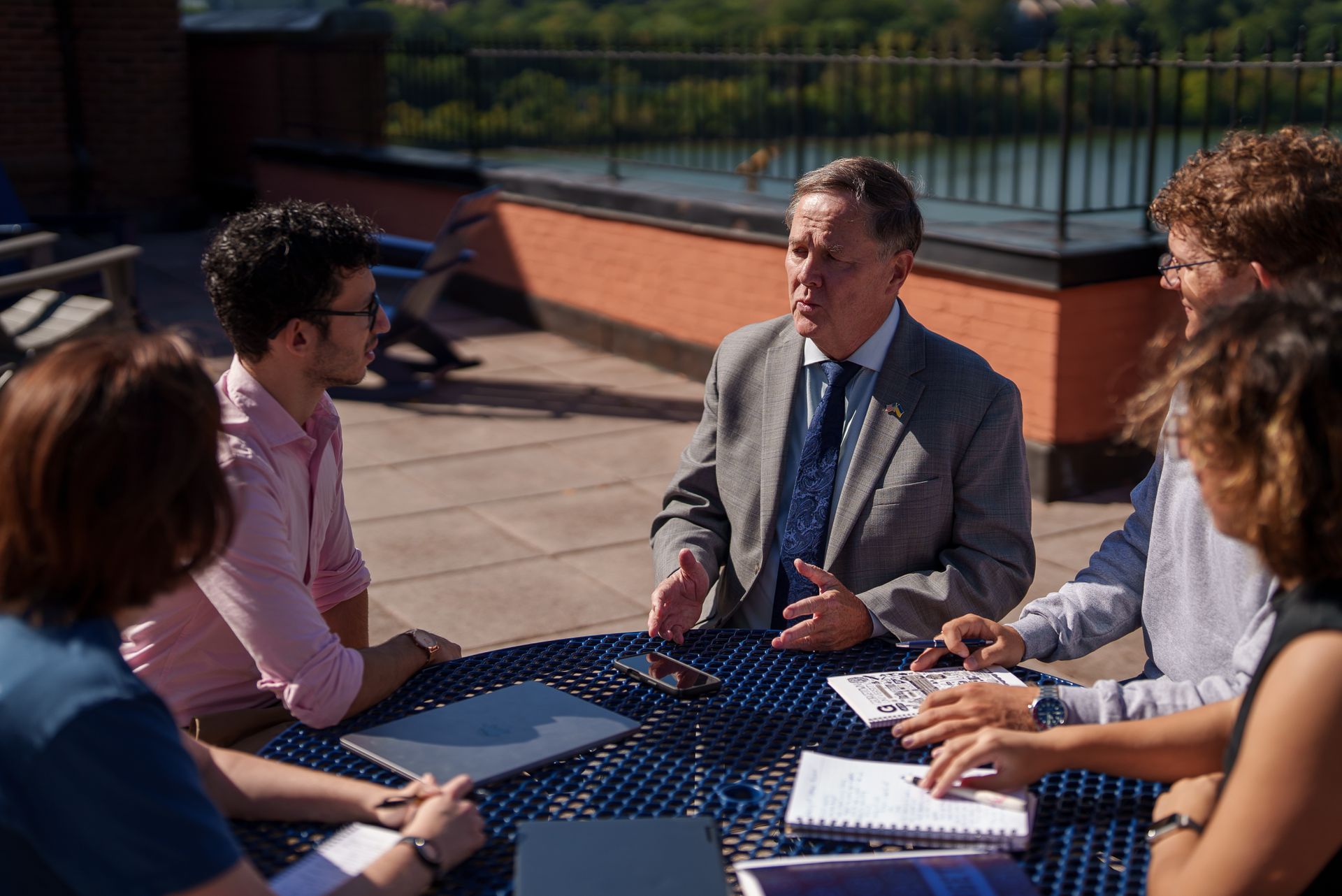 A group of students outside of the Car Barn listening to an instructor together.